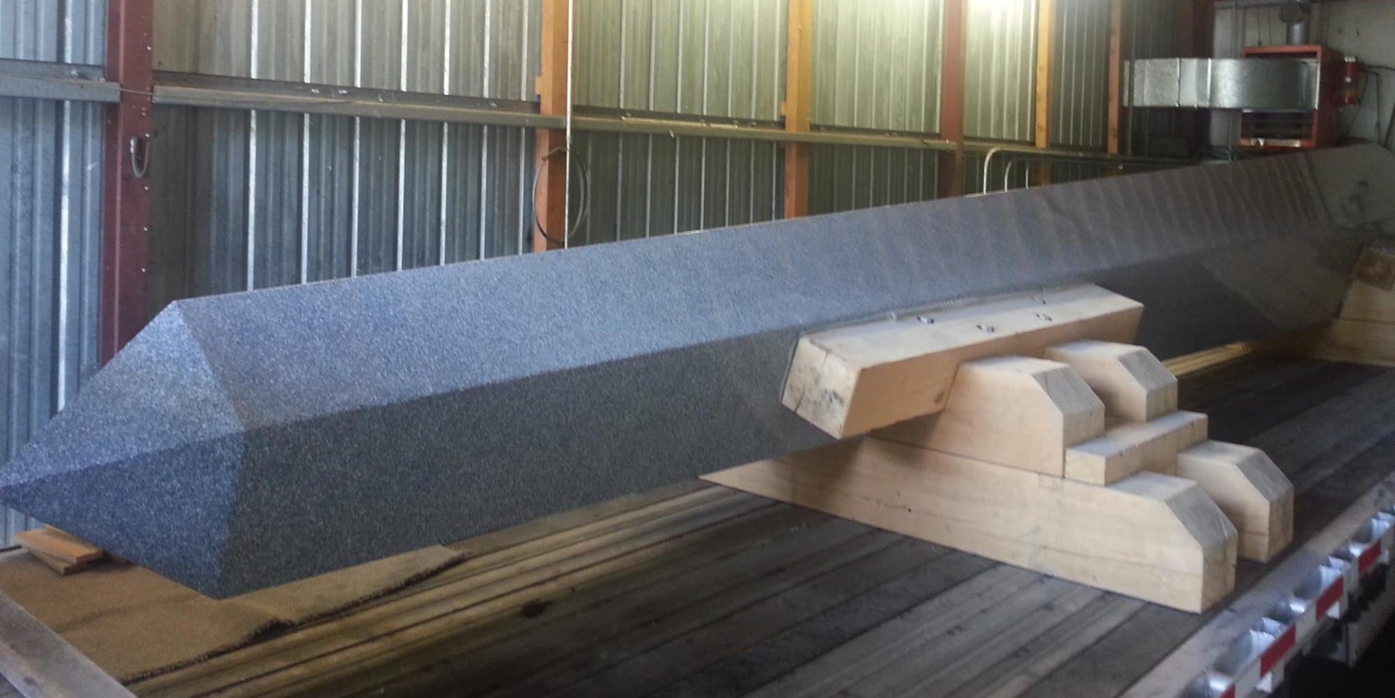 The memorial's centerpiece in the shop: a 33-foot solid granite obelisk weighing 40,000 pounds